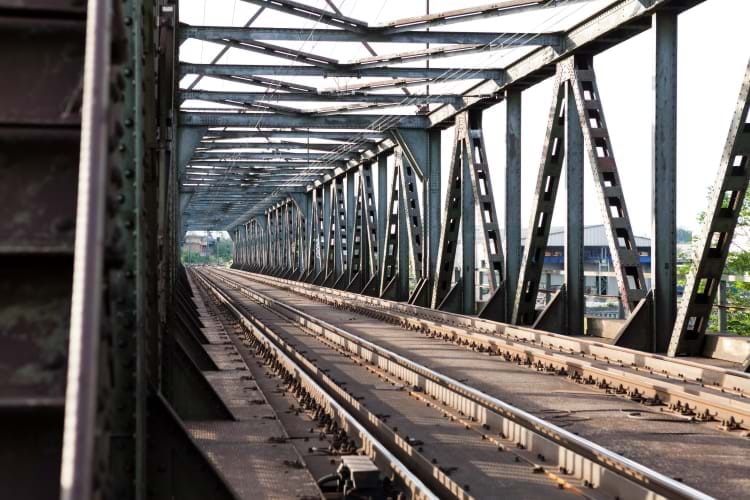 A metal truss engineered railroad bridge with two tracks