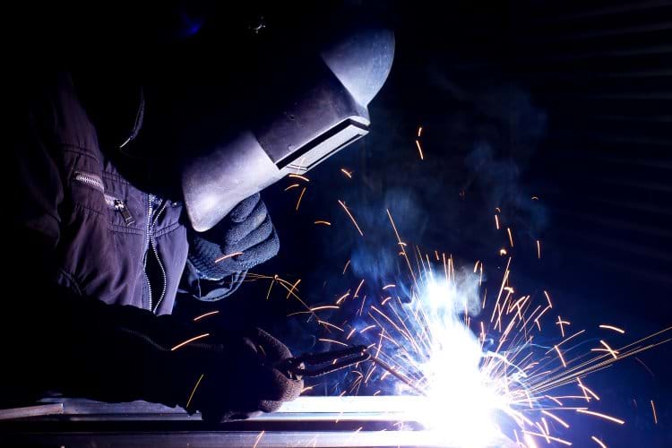 A man welding in a repair shop