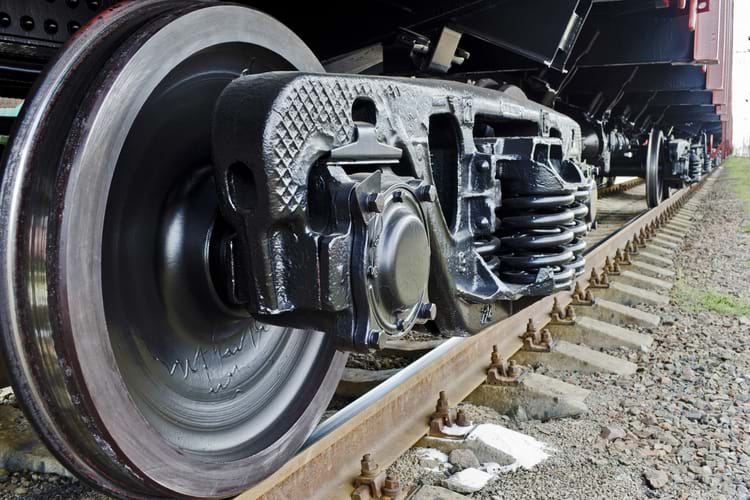 A close-up view of wheels of a freight train