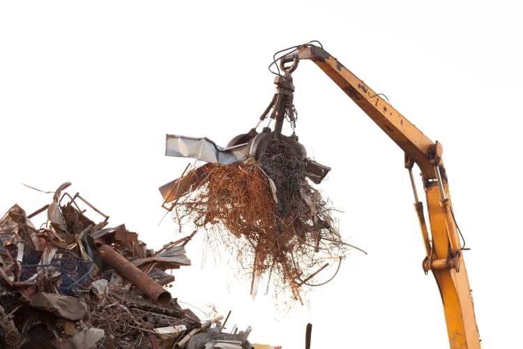 Closeup of crane claw loaded with scrap metal