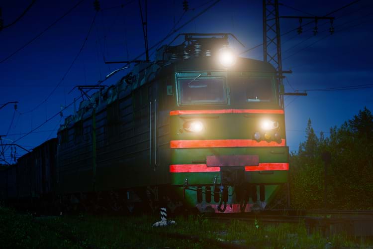 A locomotive with reflective tapes traveling at night