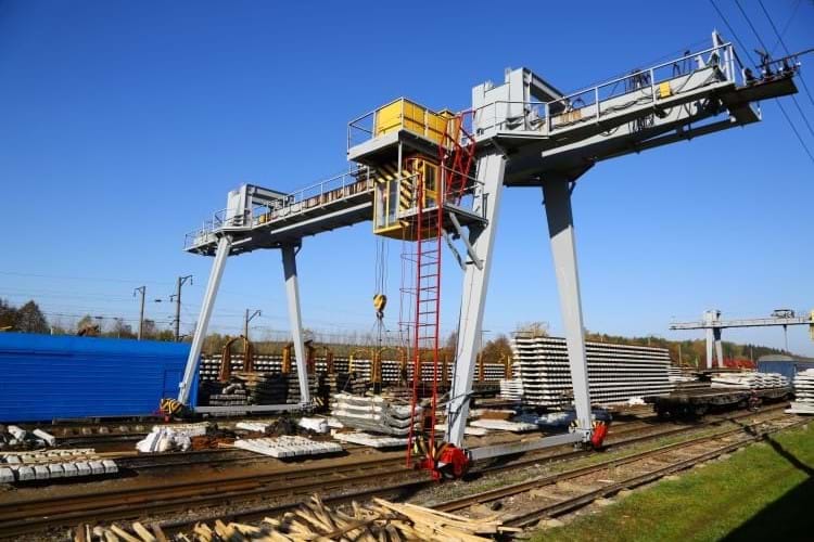 A Gantry crane loading sleepers on a railway station platform
