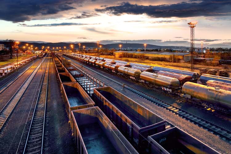 A railcar storage facility with empty freight cars at dusk