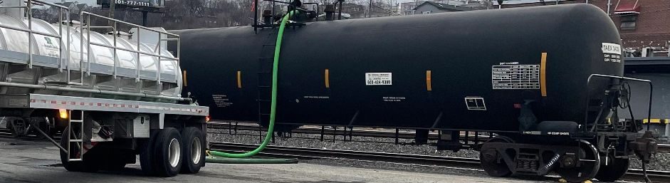 Tank car transferring product to a tank truck