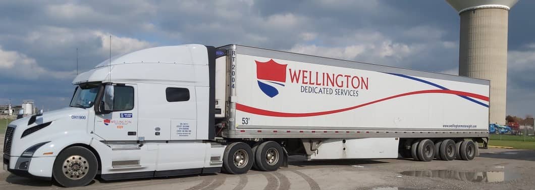 A Wellington Dedicated Services truck and trailer ready to leave the yard.